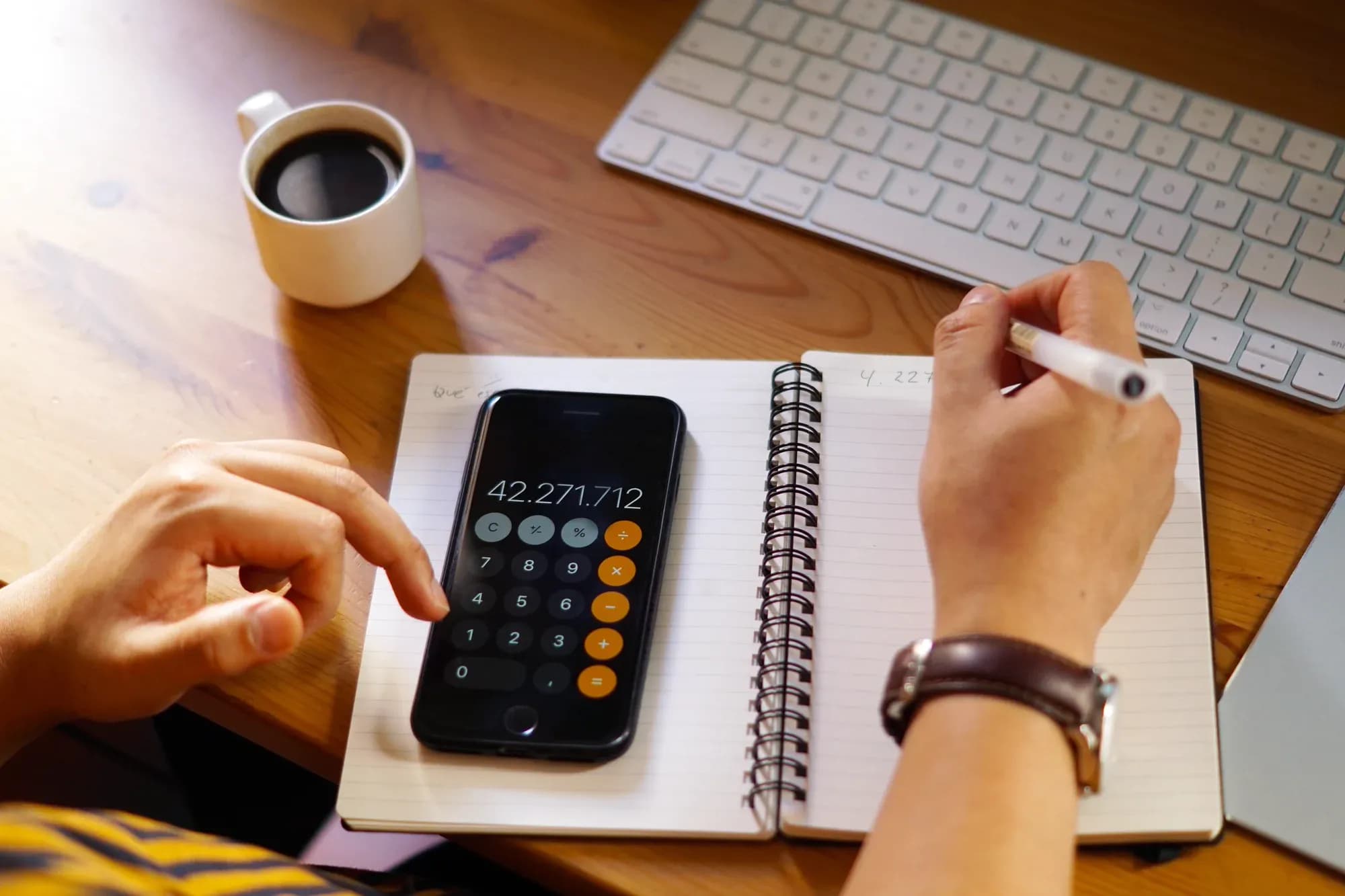 closeup-shot-entrepreneur-working-from-home-doing-calculations