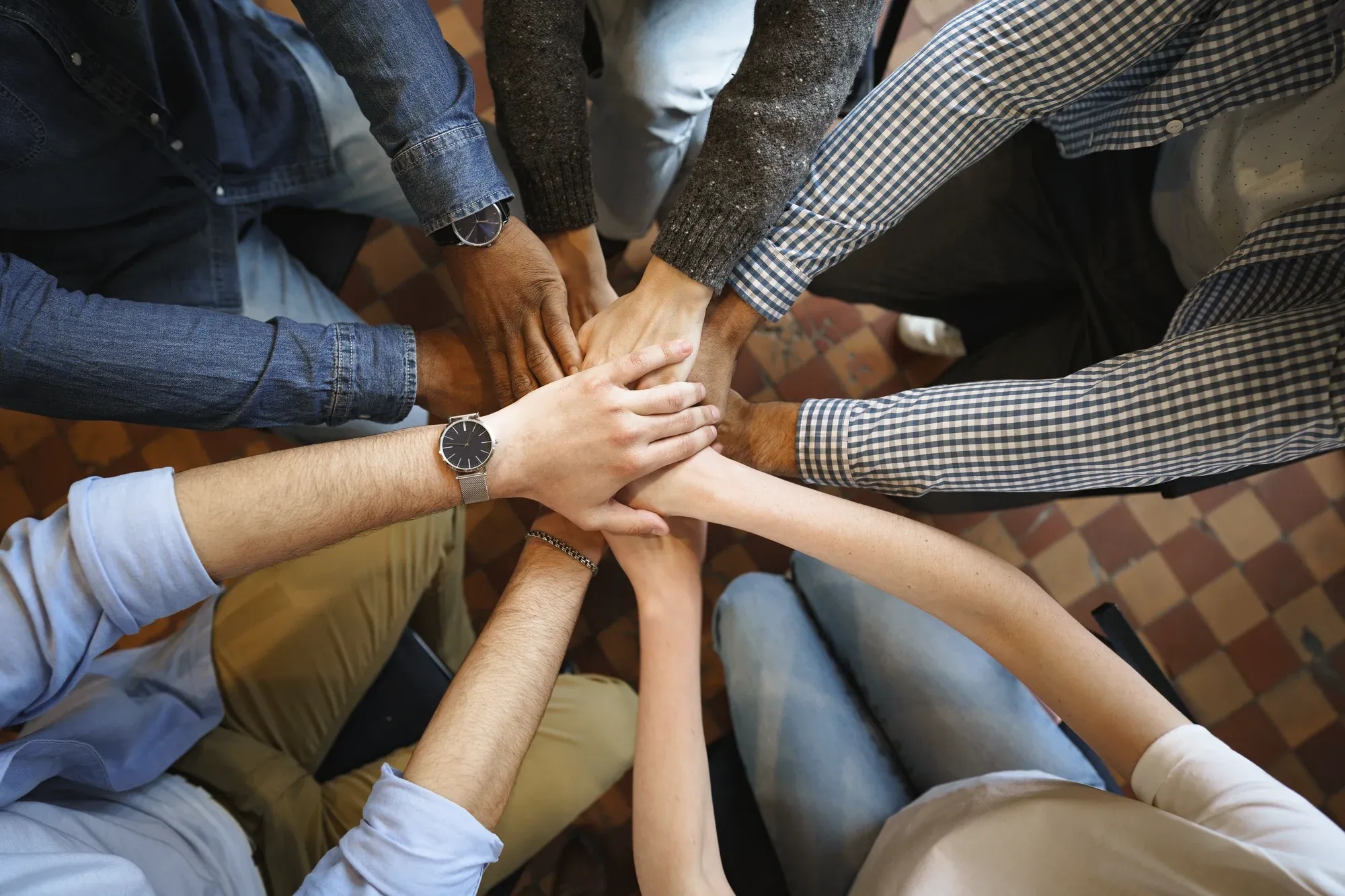 top-view-diverse-people-hands-holding-together-circle-hands-stack