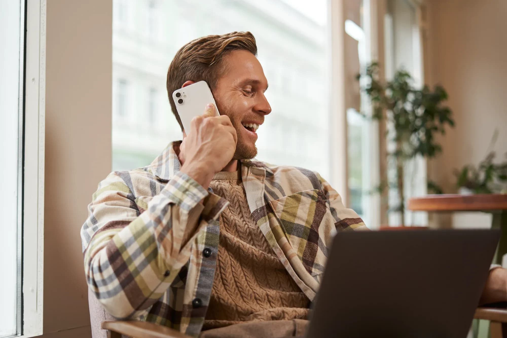 image-happy-cafe-visitor-man-with-laptop-calling-friend-phone-businessman-talking