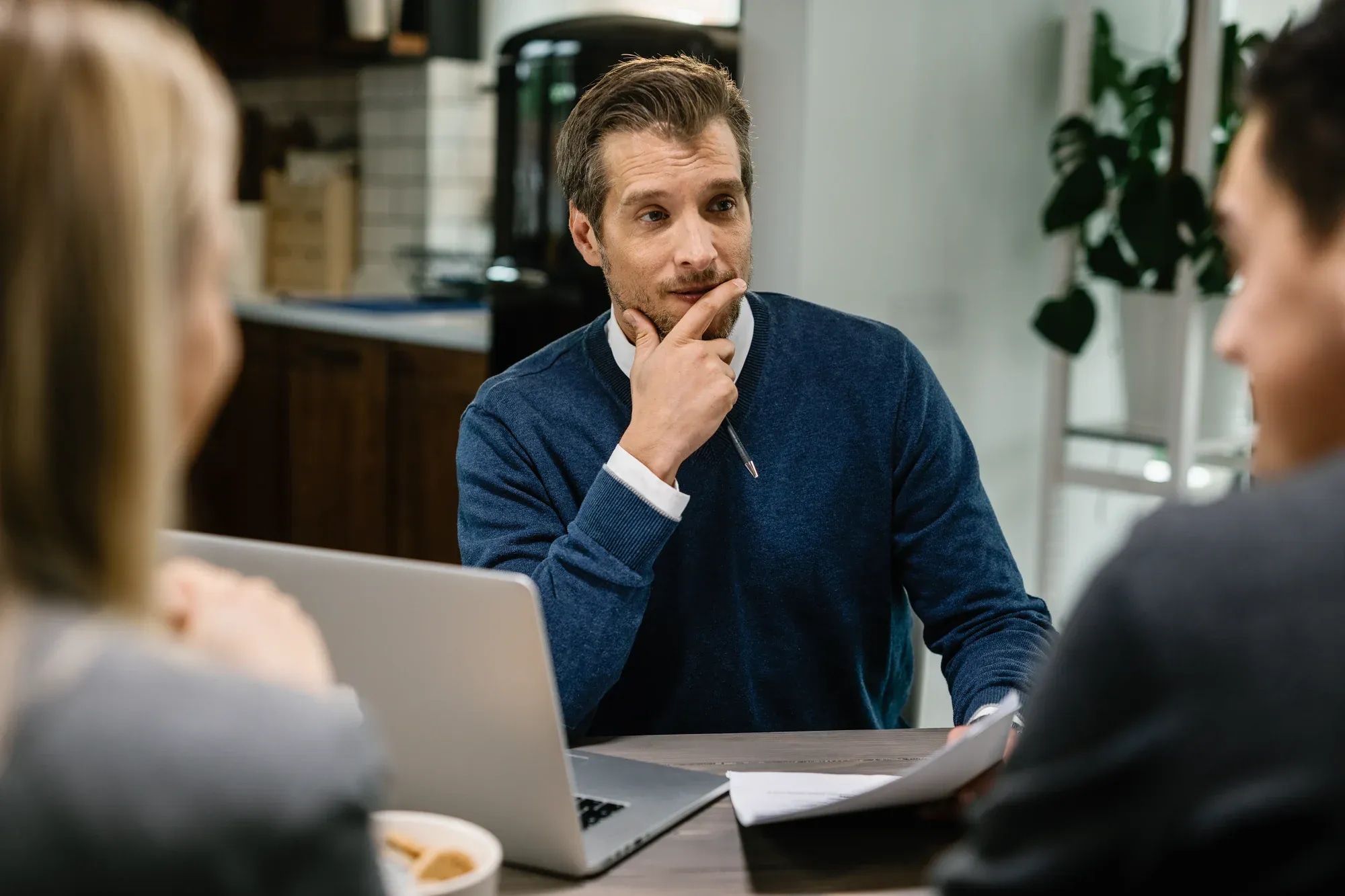 insurance-agent-having-consultations-with-couple-while-visiting-them-their-home