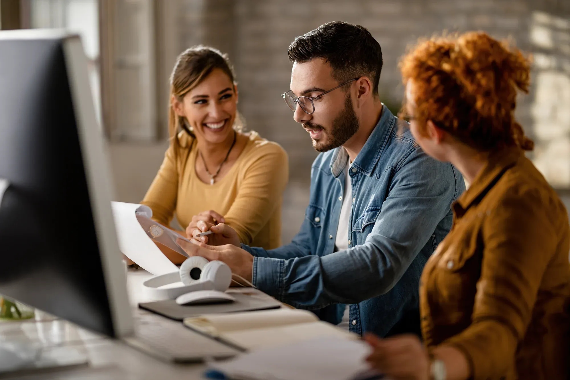 team-young-business-people-going-through-paperwork-while-working-together-office-focus-is-businessman