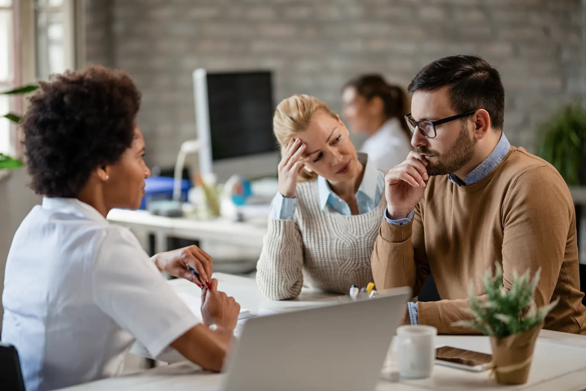 young-couple-feeling-worried-after-talking-african-american-doctor-medical-appointment
